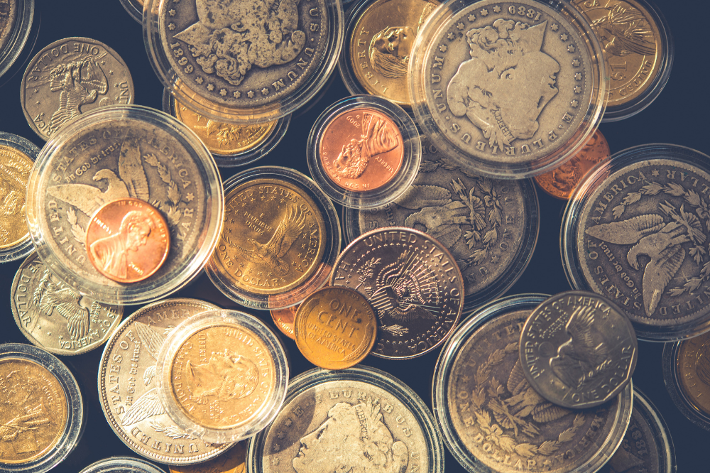 A mix of U.S. gold, silver, and copper coins in protective cases reviewed by Coin Buyers in Midland.