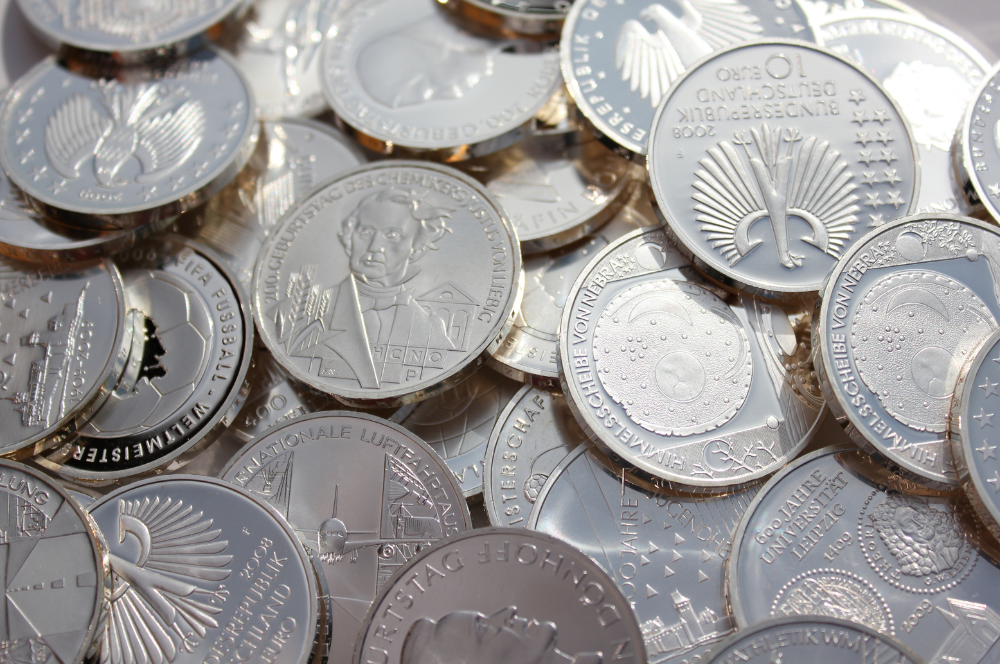 Shiny silver commemorative coins displayed together, representing collectible value handled by Coin Buyers in Midland.